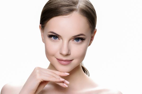 Beautiful brunette woman with beauty lashes and pink lipstick healthy skin isolated on white